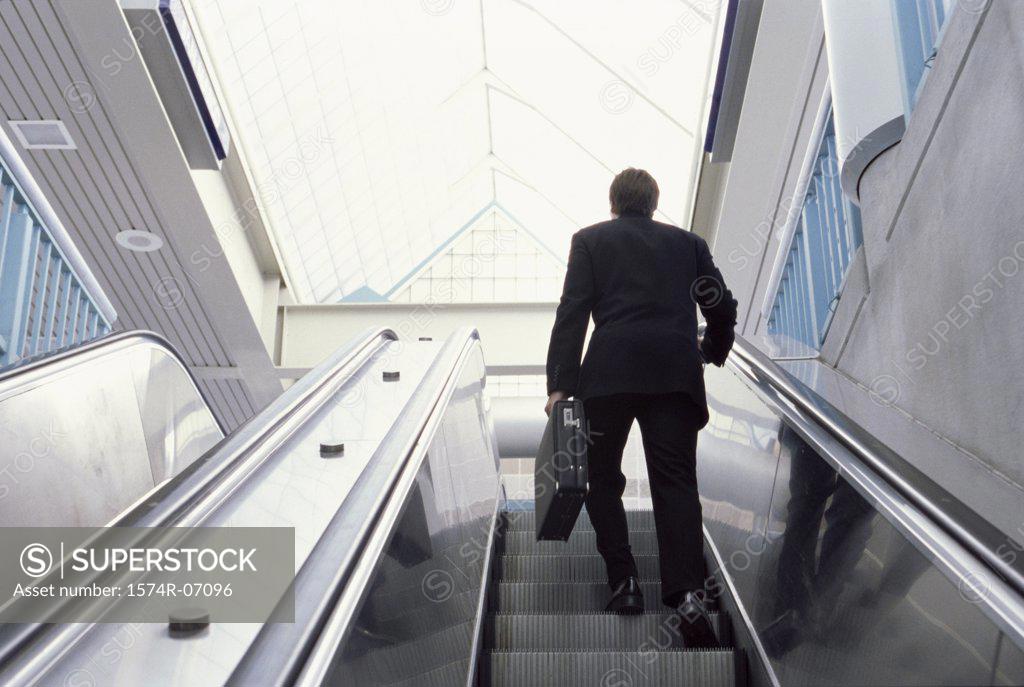 Stock Photo: 1574R-07096 Rear view of a businessman on an escalator
