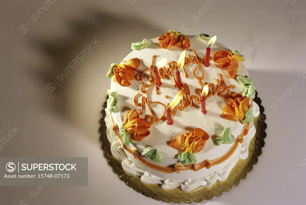 Decorated birthday cake with lit candles