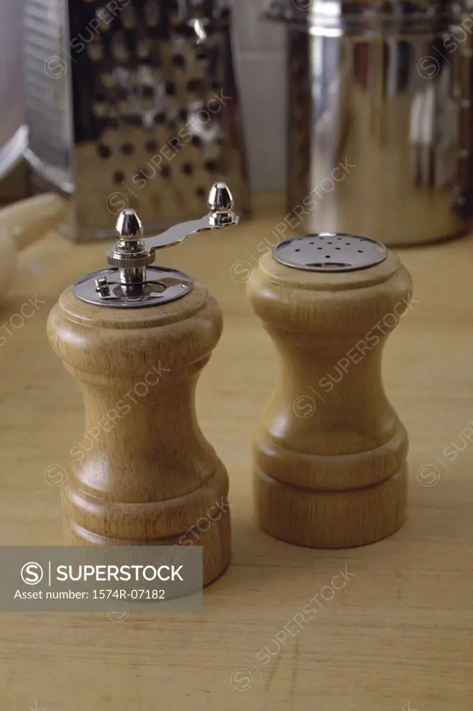 Close-up of a pepper mill and a salt shaker
