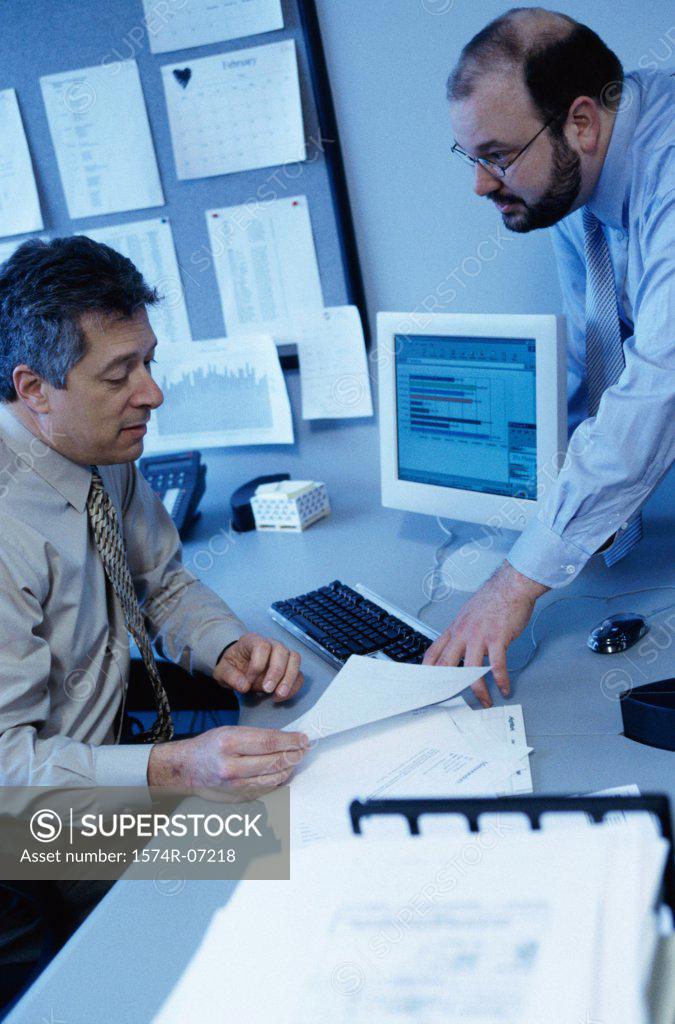 Stock Photo: 1574R-07218 Two businessmen discussing in an office