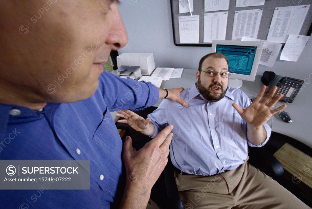 Stock Photo: 1574R-07222 Two businessmen discussing in an office