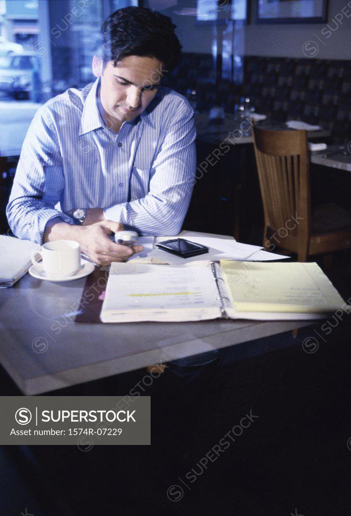 Stock Photo: 1574R-07229 Businessman operating a mobile phone