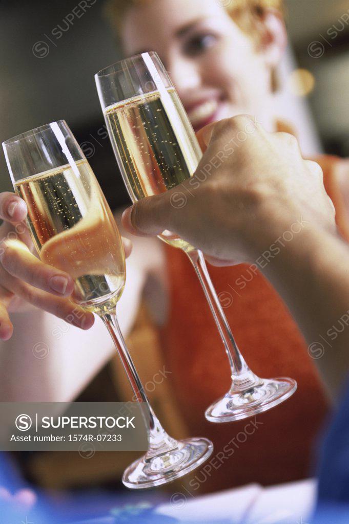 Stock Photo: 1574R-07233 Young couple toasting with Champagne