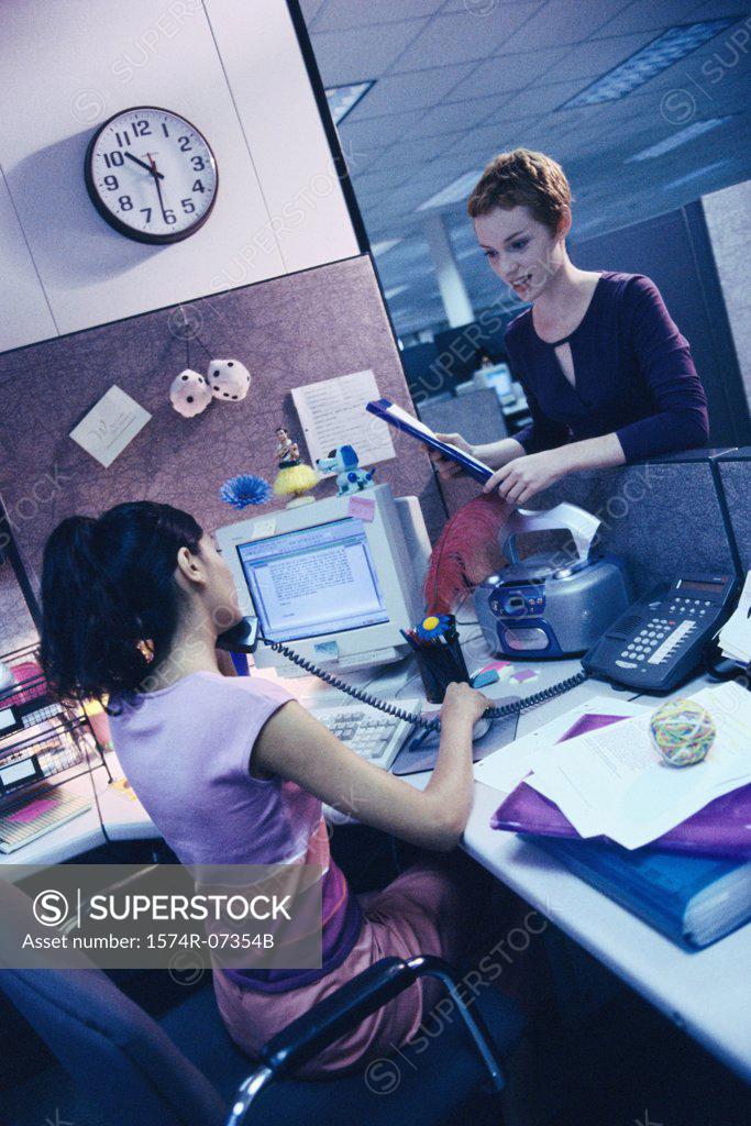 Stock Photo: 1574R-07354B Two businesswomen in an office talking