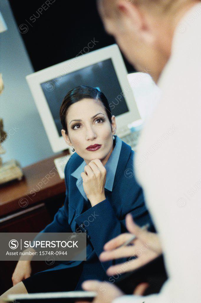 Stock Photo: 1574R-0944 Businessman and businesswoman in a meeting
