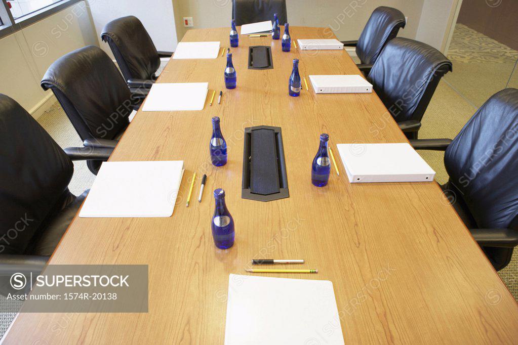Stock Photo: 1574R-20138 High angle view of water bottles and ring binder files on a conference table