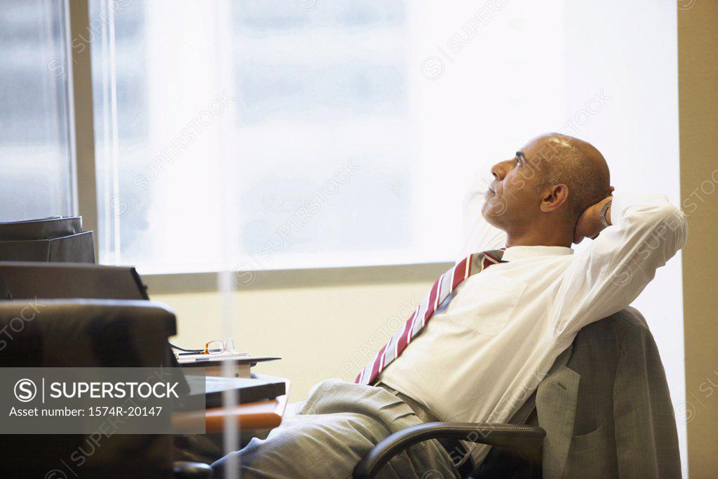 Stock Photo: 1574R-20147 Side profile of a businessman sitting in an office