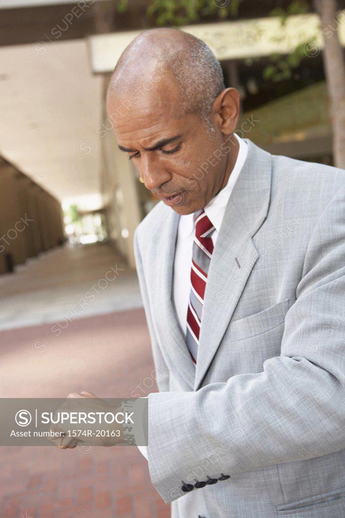 Stock Photo: 1574R-20163 Close-up of a businessman looking at his wristwatch