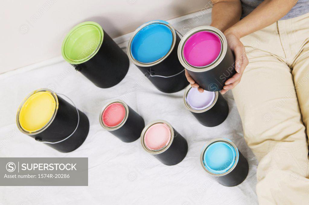 Stock Photo: 1574R-20286 High angle view of a woman sitting with paint cans beside her