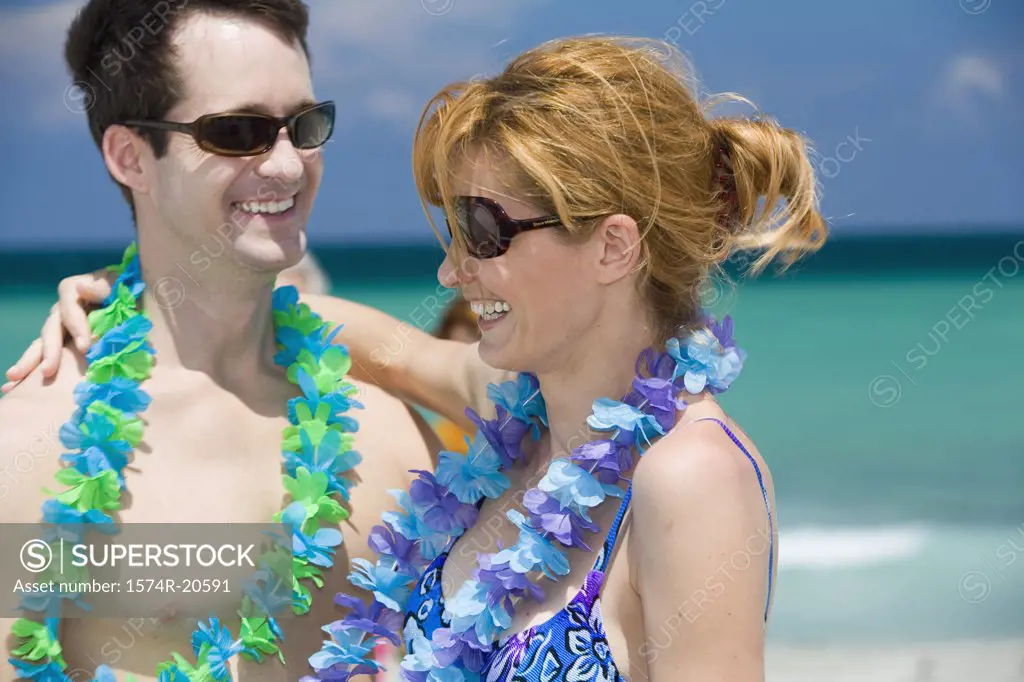 Close-up of a young couple smiling on the beach