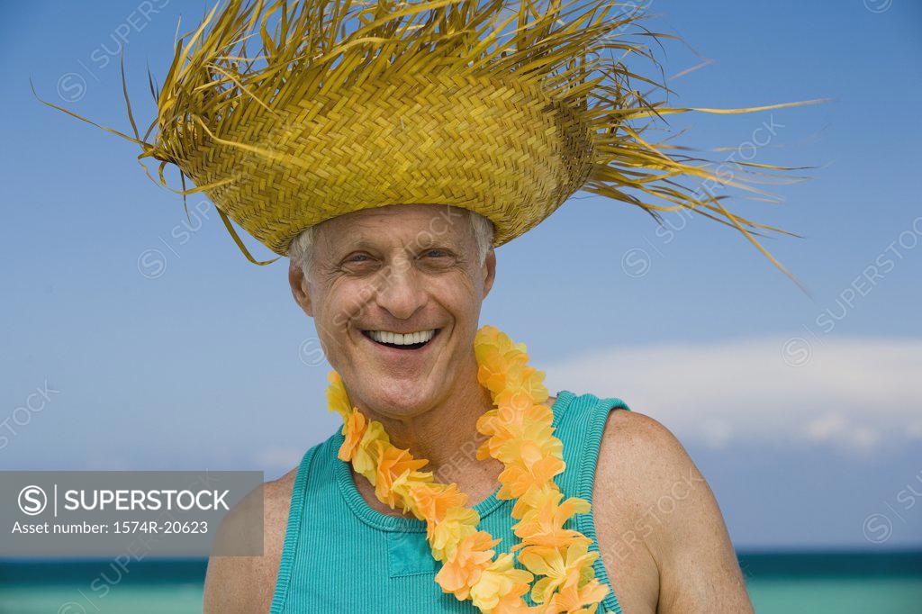 Stock Photo: 1574R-20623 Portrait of a senior man wearing a straw hat and smiling