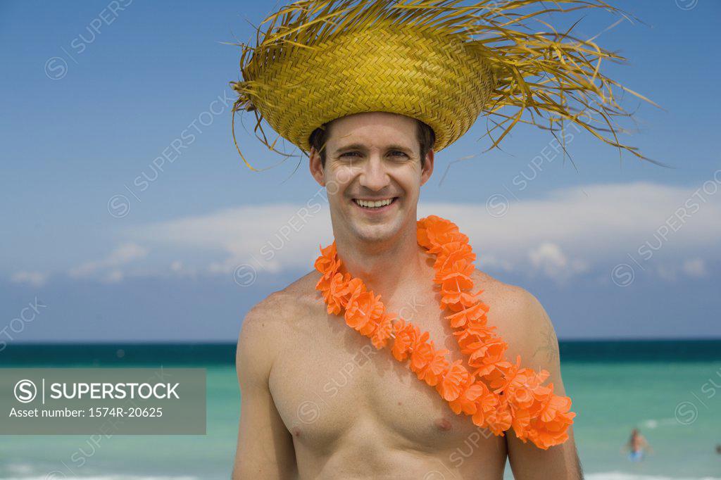 Stock Photo: 1574R-20625 Portrait of a young man wearing a straw hat and smiling