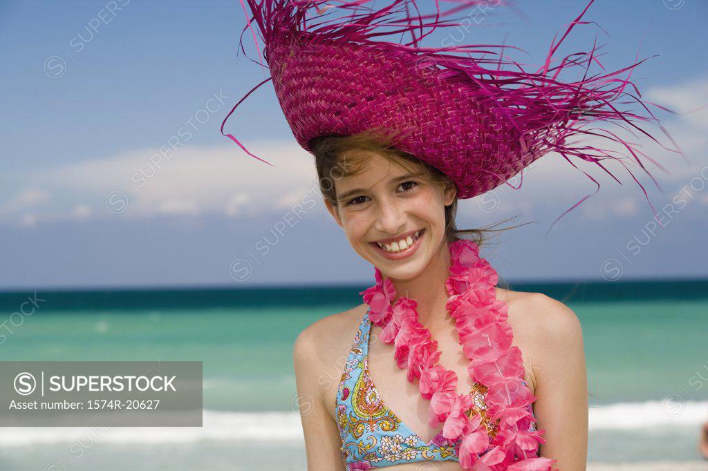 Stock Photo: 1574R-20627 Portrait of a girl wearing a straw hat and smiling