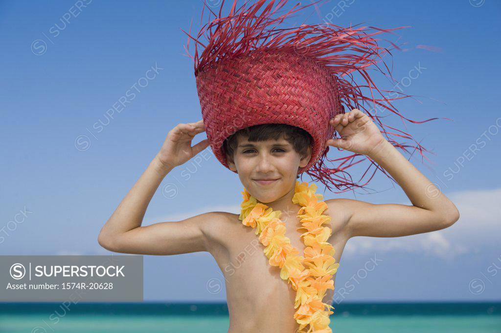 Stock Photo: 1574R-20628 Portrait of a boy wearing a straw hat and smiling