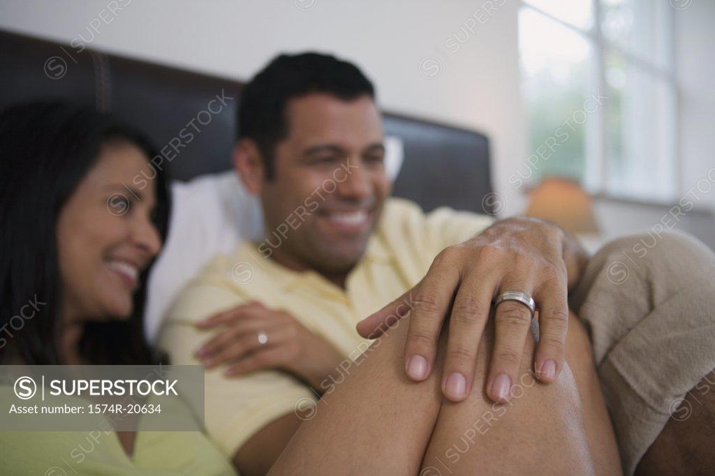Stock Photo: 1574R-20634 Close-up of a mature couple reclining in the bed and smiling