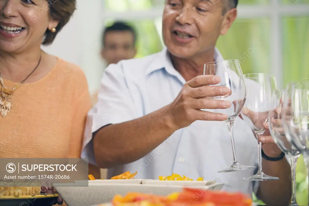 Close-up of a mature woman smiling with a mature man holding two glasses of wine