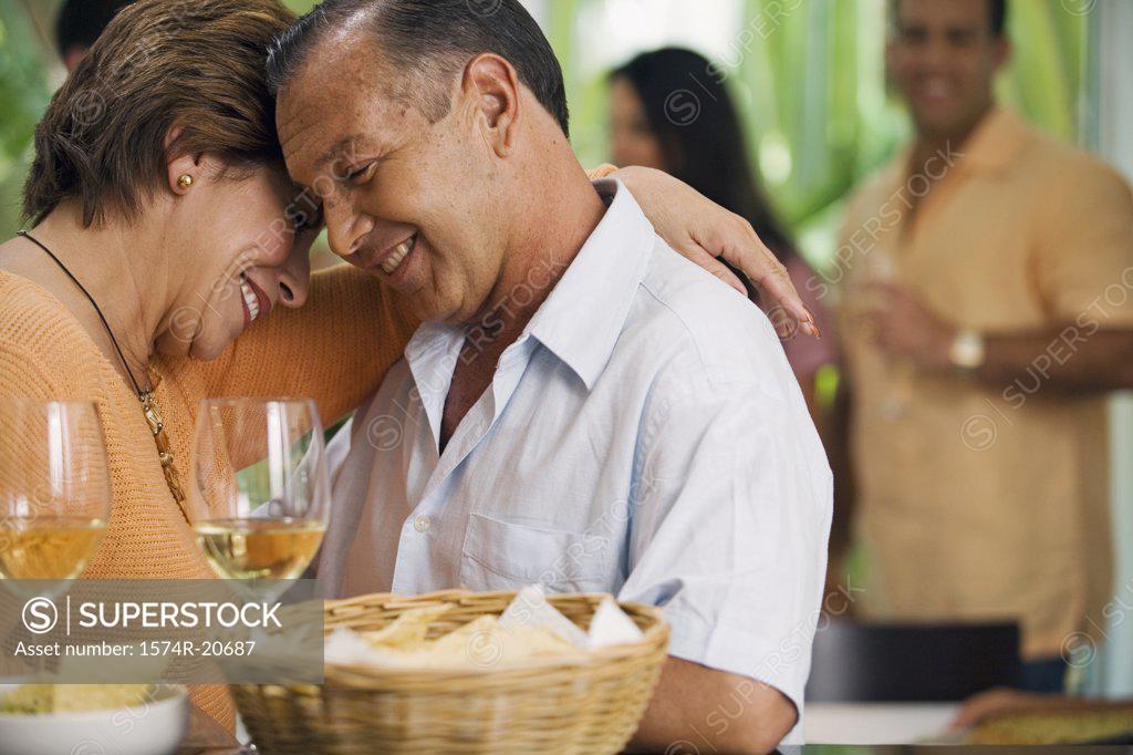 Stock Photo: 1574R-20687 Close-up of a mature couple embracing each other and smiling