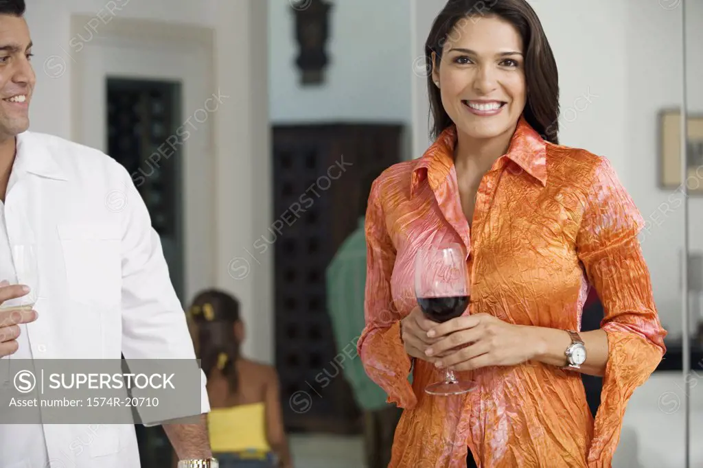 Portrait of a mid adult woman standing with a mid adult man holding wineglasses