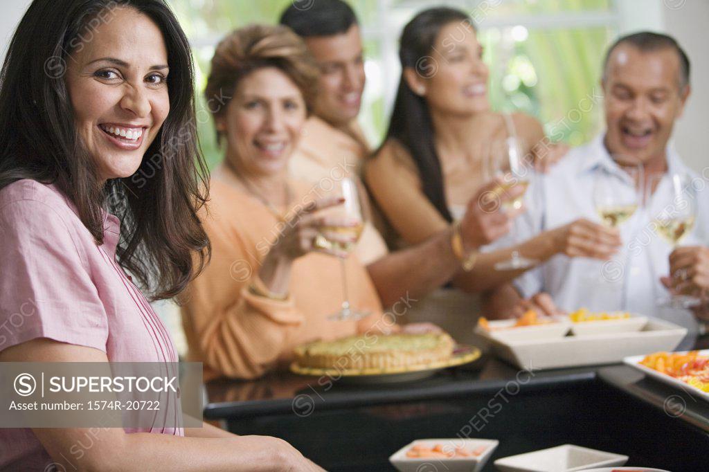 Stock Photo: 1574R-20722 Portrait of a mature woman with her friends enjoying a party