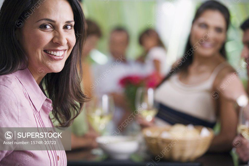 Stock Photo: 1574R-20723 Portrait of a mature woman smiling with her friends in the background