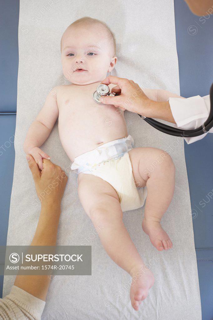 Stock Photo: 1574R-20745 High angle view of a female doctor examining a baby boy with a stethoscope