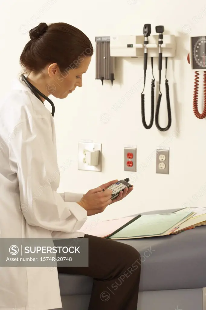 Side profile of a female doctor using a PDA