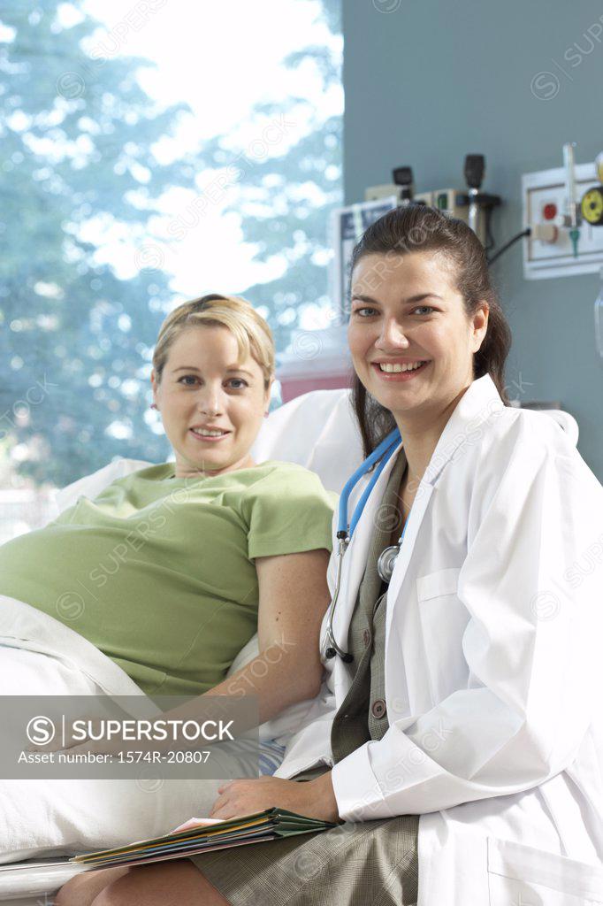 Stock Photo: 1574R-20807 Portrait of a female doctor and a pregnant woman smiling