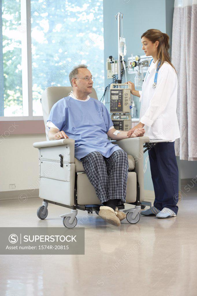 Stock Photo: 1574R-20815 Side profile of a female doctor examining a male patient