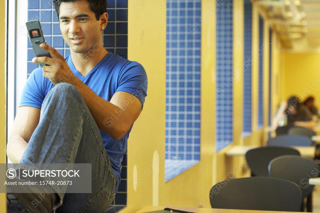 Stock Photo: 1574R-20873 Close-up of a college student using a mobile phone