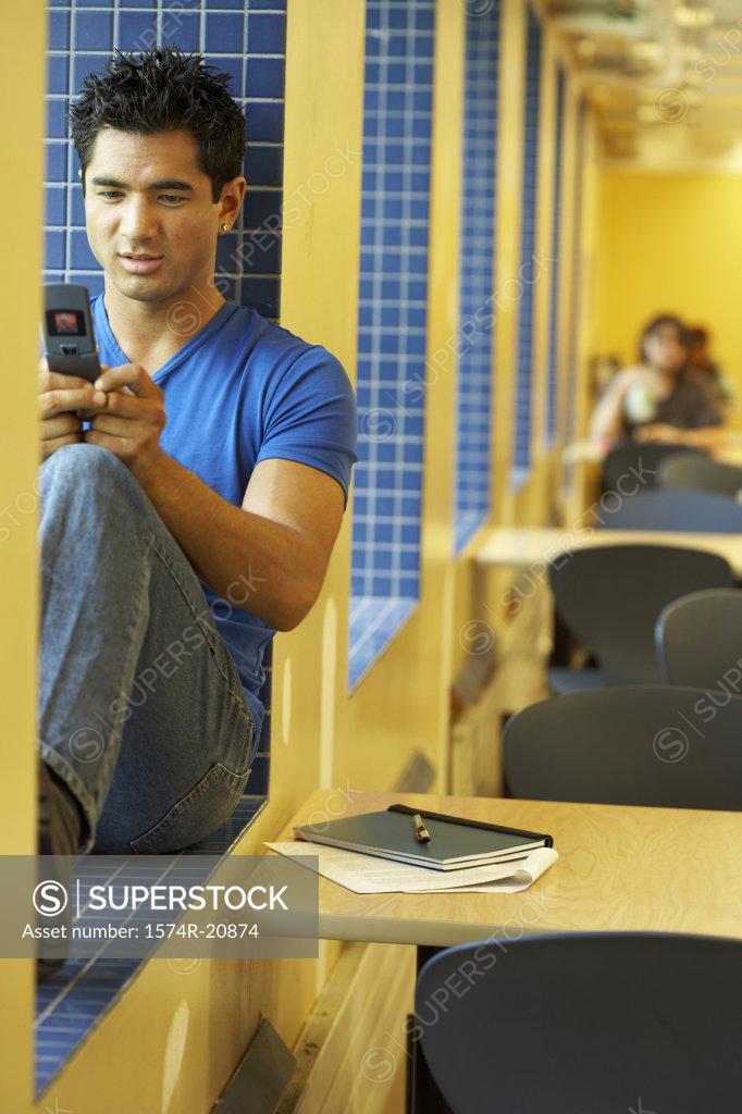 Stock Photo: 1574R-20874 College student using a mobile phone