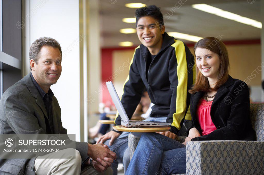 Stock Photo: 1574R-20904 Male professor sitting with his students and smiling