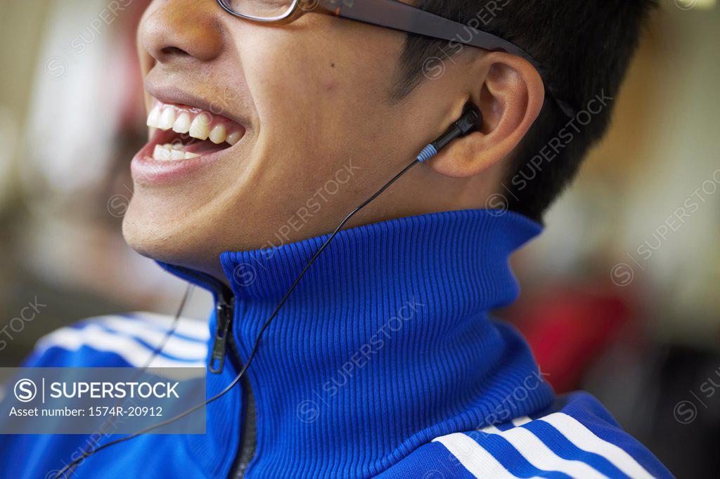 Stock Photo: 1574R-20912 Close-up of a college student wearing headphones and listening to music