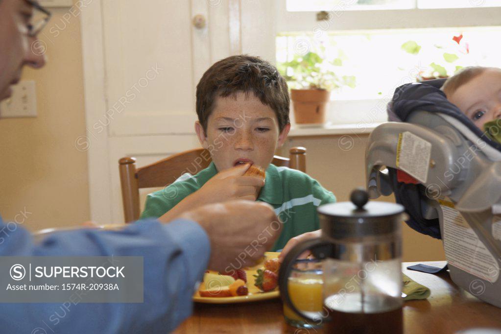 Stock Photo: 1574R-20938A Boy having breakfast with his father