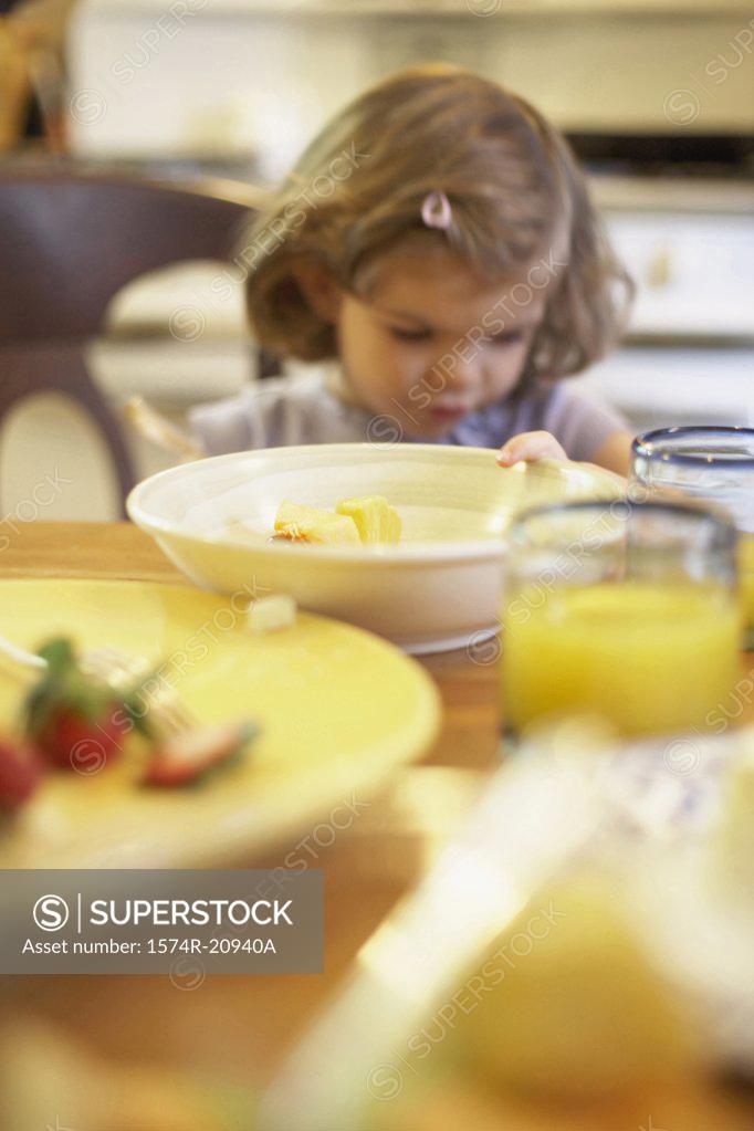 Stock Photo: 1574R-20940A Girl sitting at a dining table