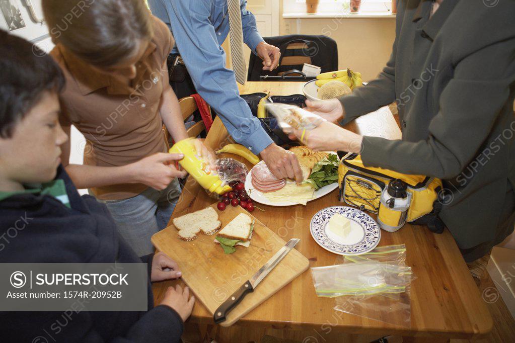Stock Photo: 1574R-20952B Mid section view of a mid adult couple with their son and daughter at a breakfast table