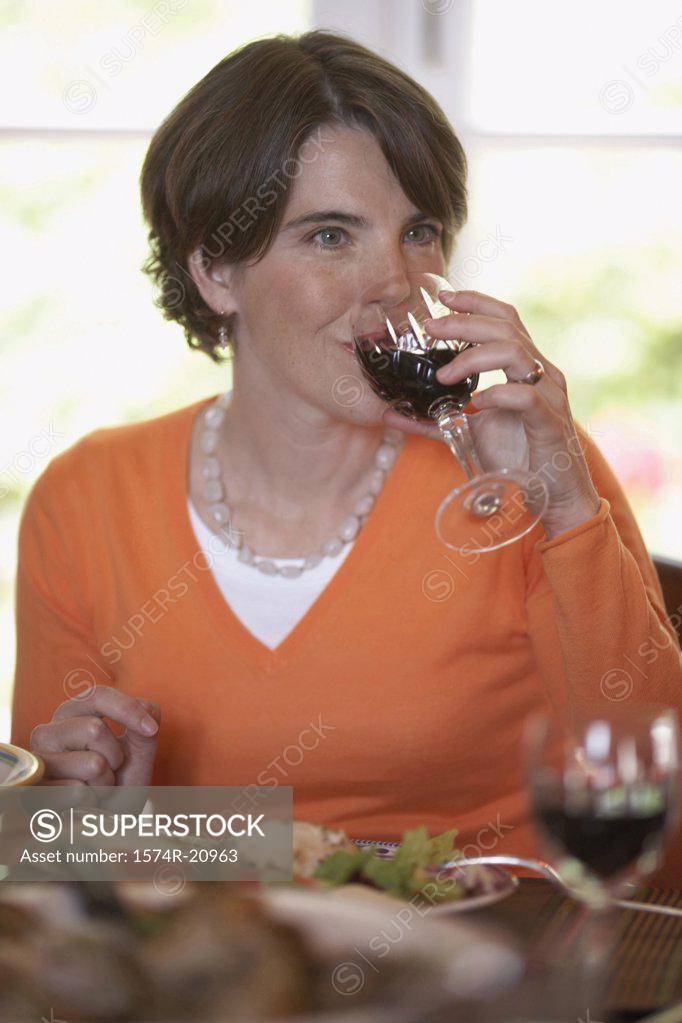 Stock Photo: 1574R-20963 Close-up of a mid adult woman drinking red wine