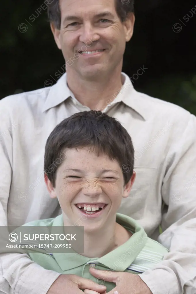 Portrait of a mid adult man smiling with his son