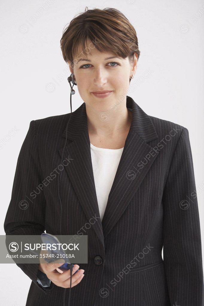 Stock Photo: 1574R-21018A Portrait of a businesswoman using a hands free device