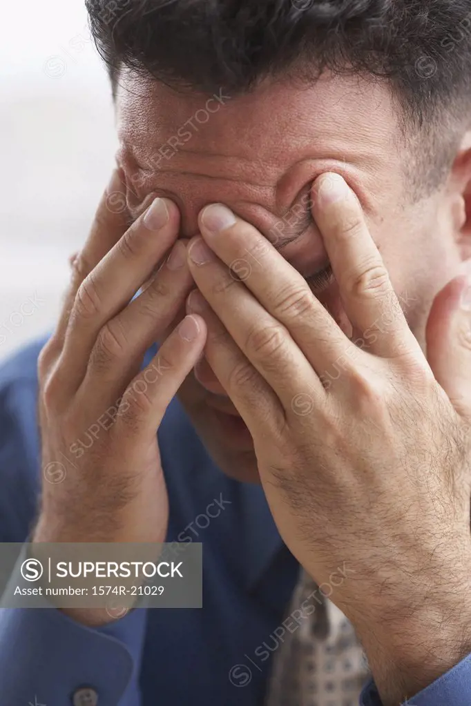 Close-up of a businessman suffering from a headache