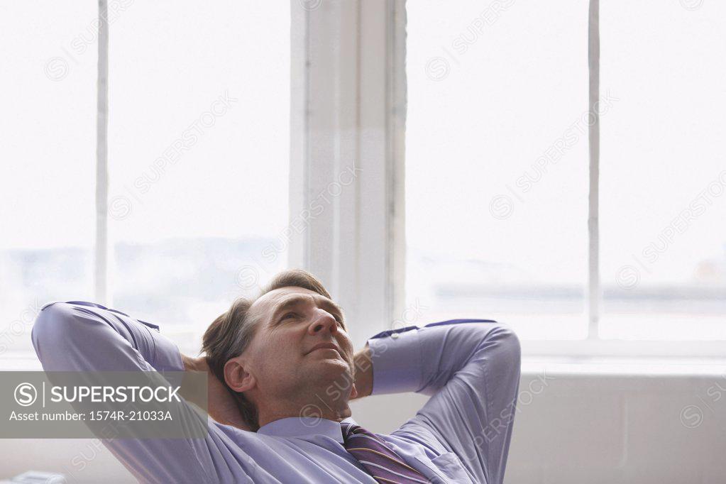 Stock Photo: 1574R-21033A Businessman with his hands behind his head