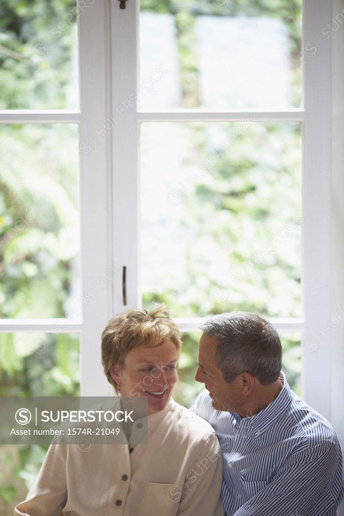 Stock Photo: 1574R-21049 Close-up of a mature couple smiling at each other