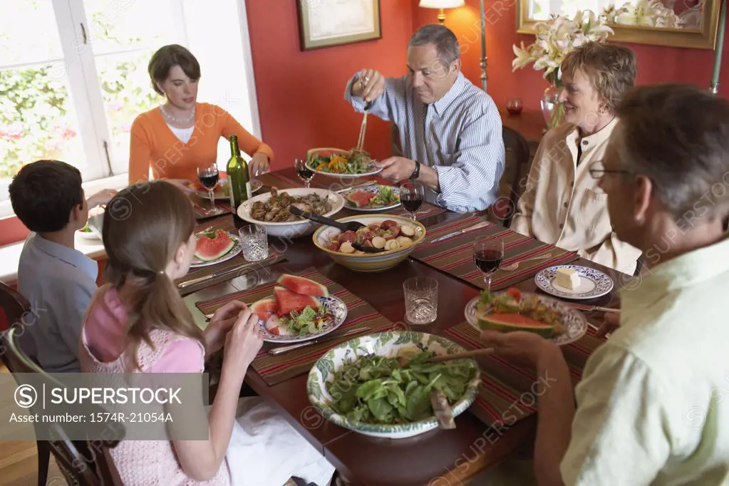 High angle view of a family sitting at a dining table