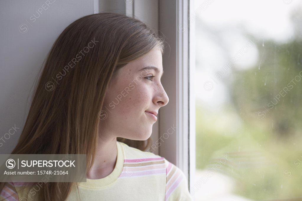 Stock Photo: 1574R-21064 Close-up of a teenage girl looking through a window