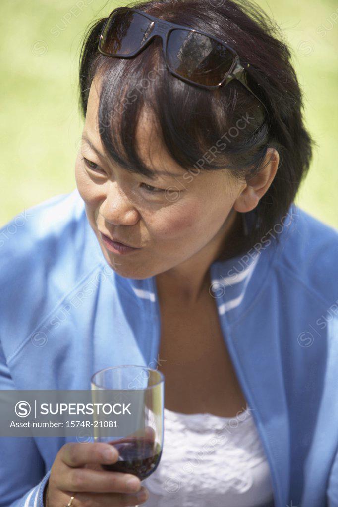 Stock Photo: 1574R-21081 Close-up of a mature woman holding a glass of red wine