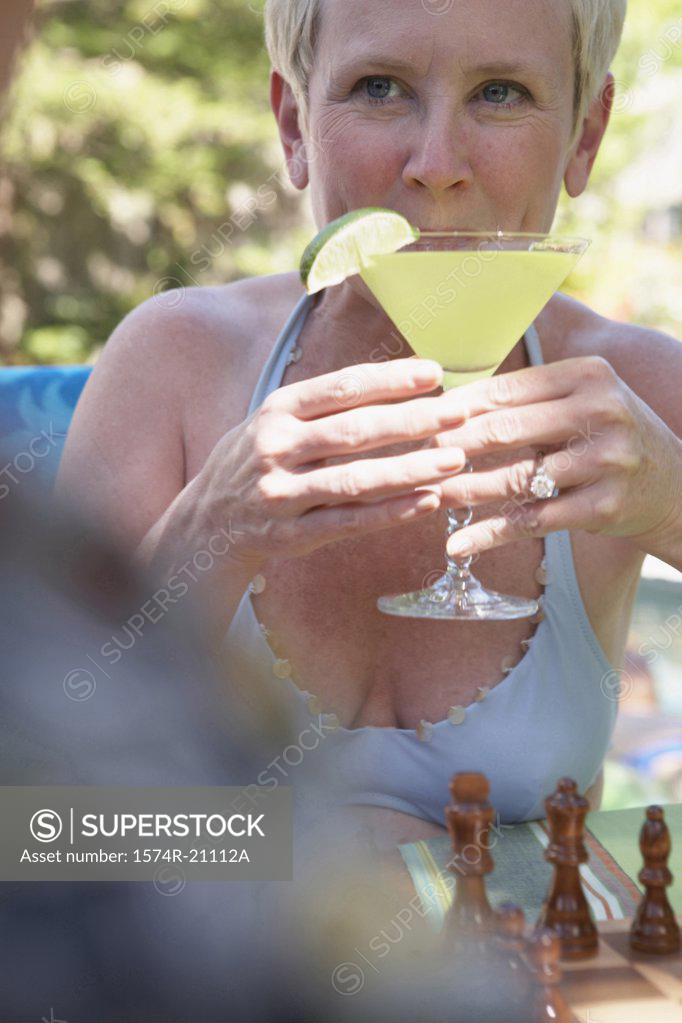 Stock Photo: 1574R-21112A Close-up of a mature woman drinking a martini