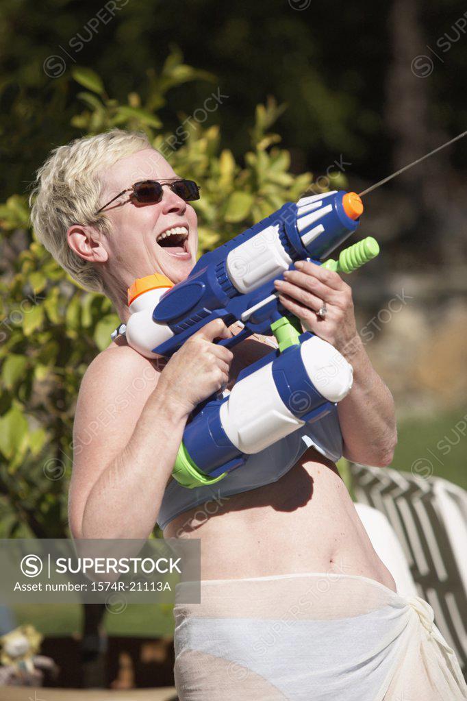 Stock Photo: 1574R-21113A Close-up of a mature woman spraying water with a squirt gun