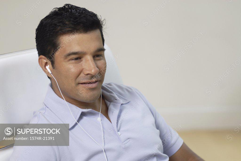 Stock Photo: 1574R-21391 Close-up of a businessman wearing headphones and listening to music