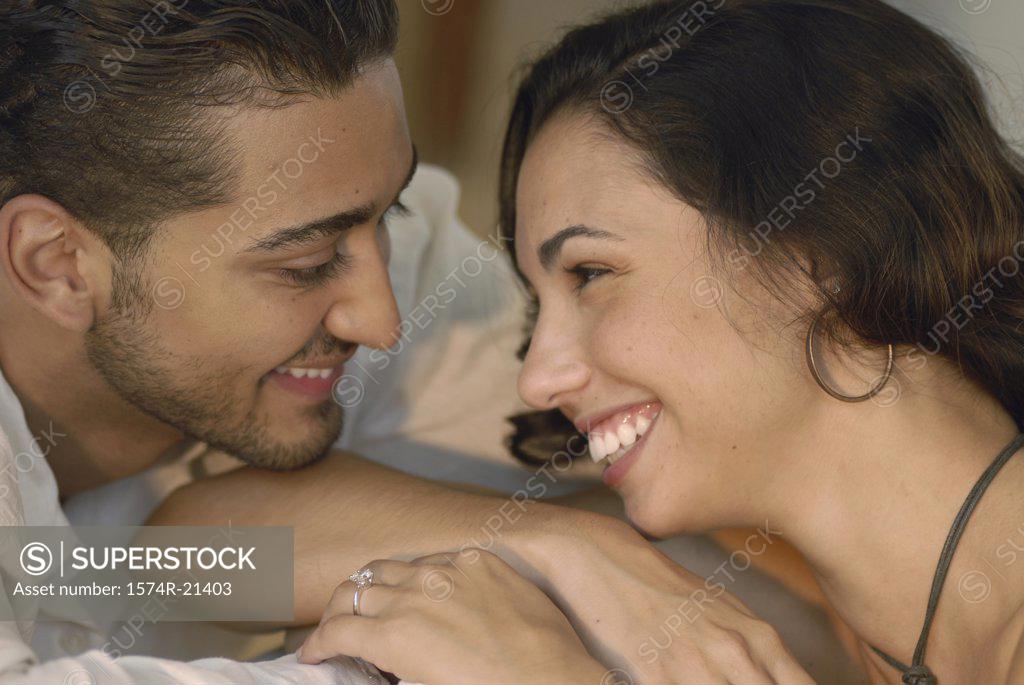 Stock Photo: 1574R-21403 Close-up of a young couple smiling at each other