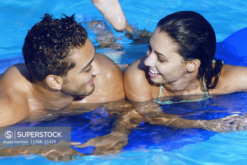 Stock Photo: 1574R-21459 High angle view of a young couple leaning on a pool raft in a swimming pool