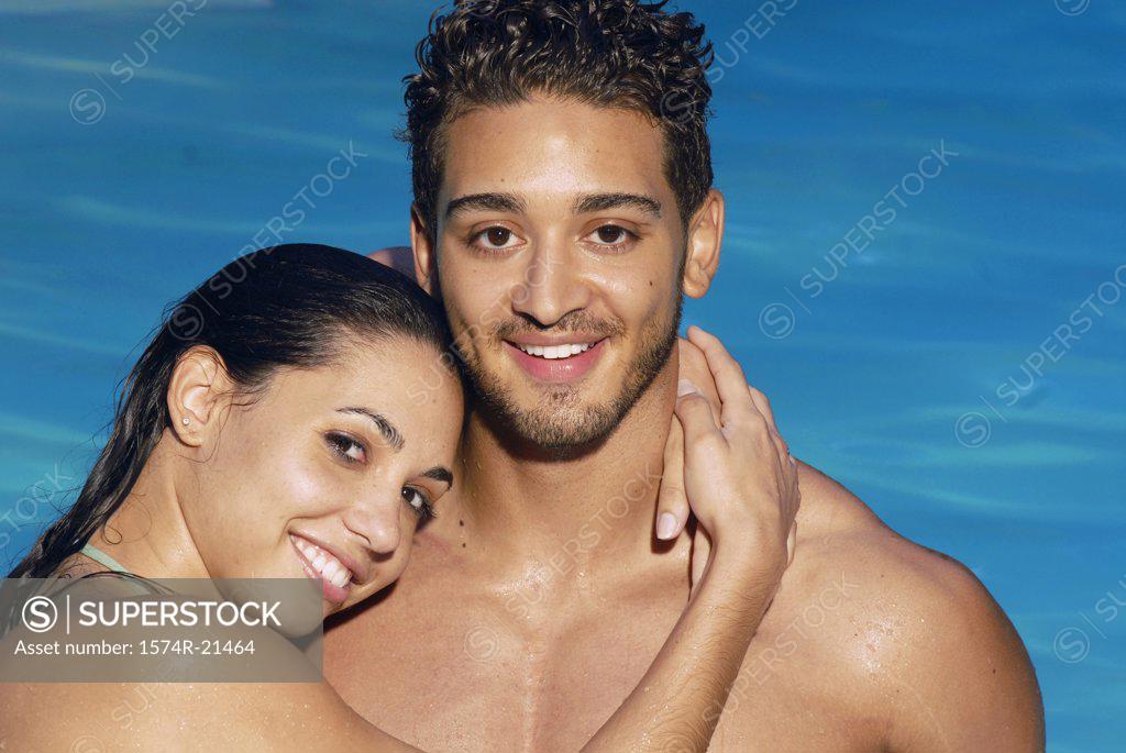 Stock Photo: 1574R-21464 Portrait of a young woman embracing a young man and smiling